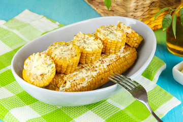 Flavored boiled corn on  plate on wooden table close-up