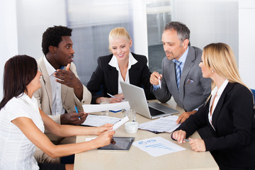 Group Of Businesspeople Discussing Together