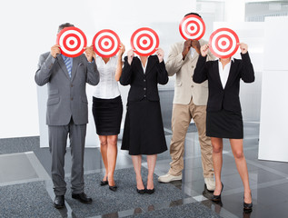Businesspeople Holding Dartboard