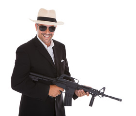 Mature Businessman Holding Gun