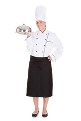 Portrait Of Female Chef Holding Tray