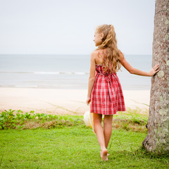 Adorable happy smiling girl on beach vacation