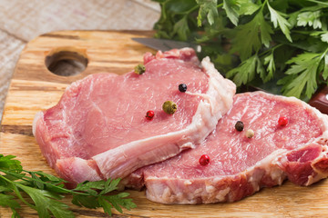 Fresh raw meat on wooden background