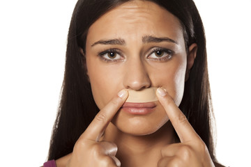 patch under her nose because of bad waxing her mustache