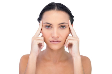 Young model posing while touching her forehead