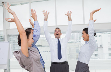 Enthusiastic work team cheering together