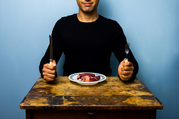 Young man having a heart for lunch - obrazy, fototapety, plakaty