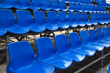 Empty plastic seats at stadium, open door sports arena.