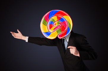 Businessman holding a lollipop
