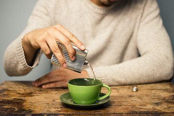 Man adding alcohol to his coffee