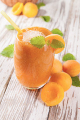 Fresh apricot drink on wood