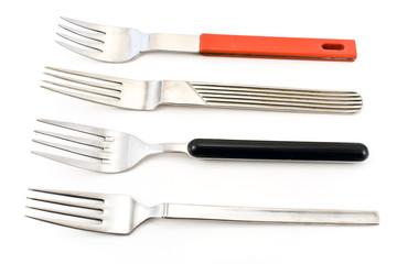 Four silver forks isolated over white background.