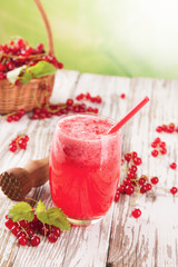 Fresh currant drink on wood