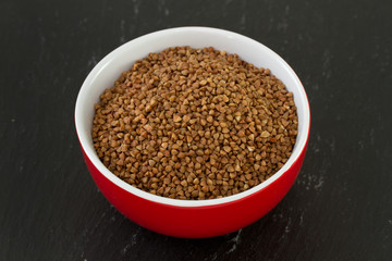 buckwheat in bowl in dark background