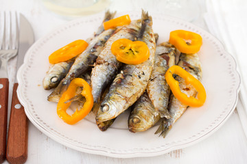 sardines with pepper on the white plate