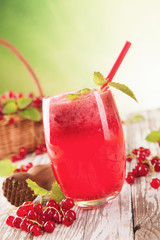 Fresh currant drink on wood