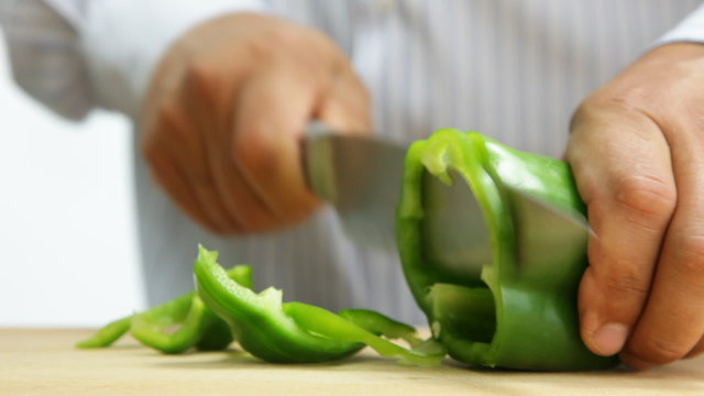 Man cutting green pepper