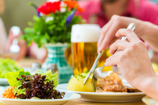 Leute in Bayerischer Tracht essen in Wirtschaft 