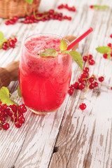 Fresh currant drink on wood