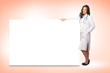 young woman doctor standing near a blank banner