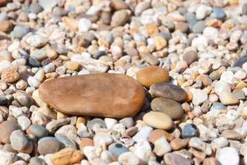 Fototapeta na wymiar Stone foot on the stony beach