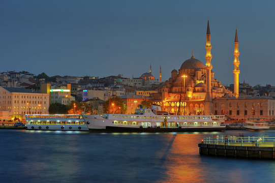 Yenicami - istanbul mosque and ferryboat in blue evening