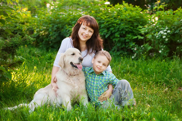 Family with their dog on the lawn