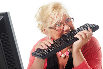 mature woman bites on the keyboard