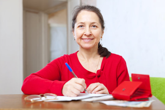 joyful  woman with bill and money