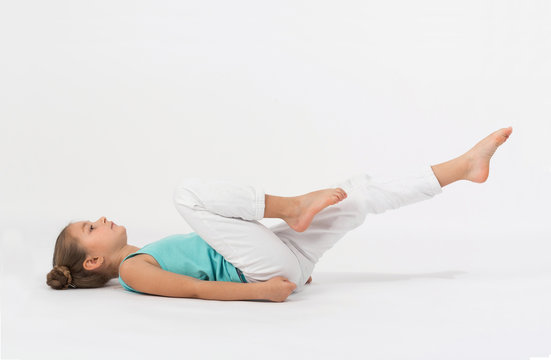 A Girl Makes Gymnastic Exercise Lying On Your Back