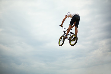 Fototapeta na wymiar Guy jumps on bike