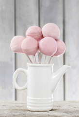 Cake pops on wooden table.