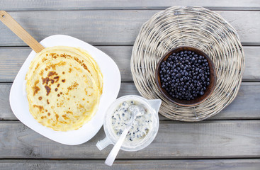 Top view of making pancakes. Pastry, creamy filling and bowl