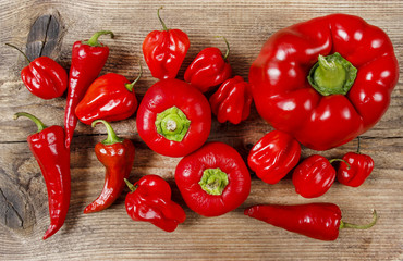 Set of red peppers on wooden background