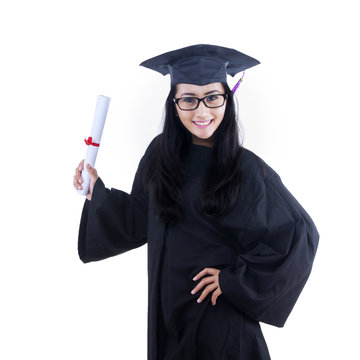 Excited graduate student in gown posing in studio