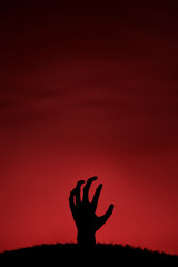 Naklejka premium Zombie hand coming up