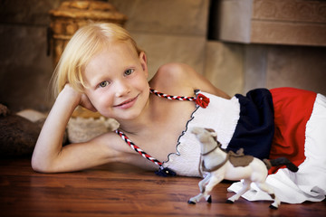 Portrait of a little girl playing with a horse © linkova