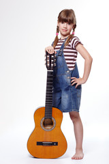 Cool girl wearing bib jeans with a guitar