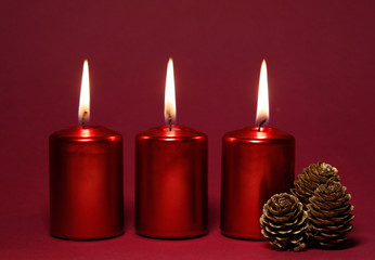 Three burning red candles