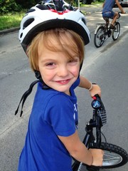 young boy with bicycle and helmet