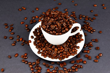 Coffee cup on a dish and coffee beans