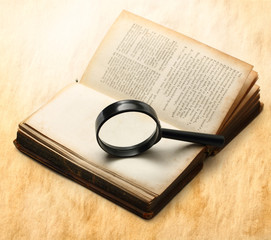 Magnifying glass and old book