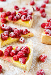 raspberry tart cut into pieces