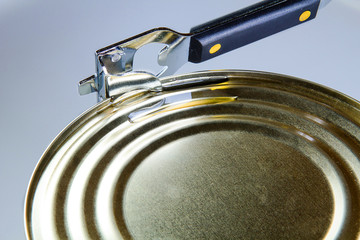 Tin opener opening a can of food