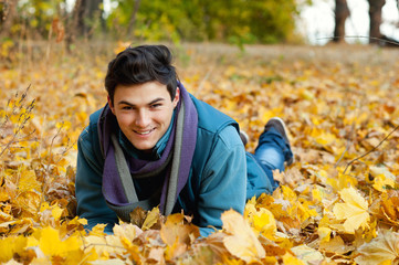 Young man laying in park.