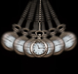 Pocket watch swinging on a chain black background - 55270755