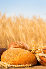 Homemade bread and wheat on the wooden table