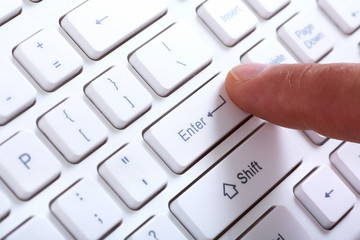 Finger with a computer keyboard.