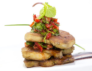 Roast goose liver is decorated with greens and strawberries