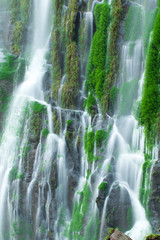 Fototapeta na wymiar Detail of a waterfall with blurred motion